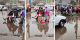 Ingenio peruano: transeúntes no pueden pasar por pista inundada y hombre los lleva en carretilla