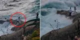 Novios son arrastrados por gigantesca ola durante sesión de fotos en la playa [VIDEO]