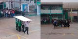 Piura: alumnos usan plancha de madera como paraguas para cruzar patio de colegio y suspenden las clases