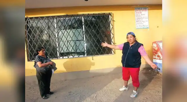 Una pobladora muestra los vidrios rotos del local comunal de la zona.
