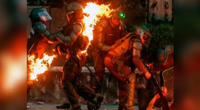 Manifestantes intentan quemar a Carabineros lanzándoles bomba molotov en Santiago de Chile