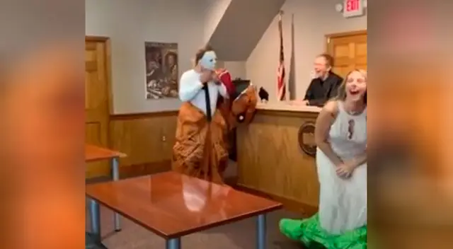 Pareja aficionada al día de Halloween se casa disfrazada de dinosaurio