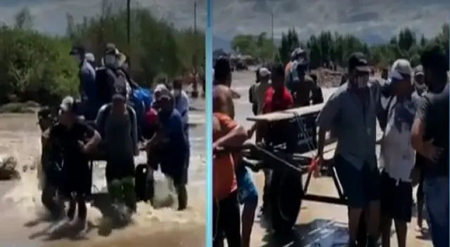 Los ciudadanos utilizan carretas humanas para poder cruzar el caudal para evitar ser arrastrados por la corriente. Los ciudadanos utilizan carretas humanas para poder cruzar el caudal para evitar ser arrastrados por la corriente.