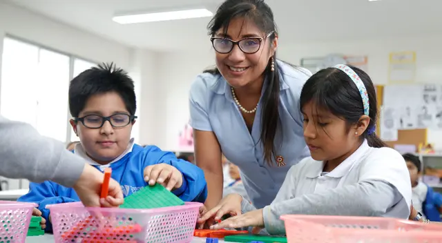 Docente enseñando en un salón de clases antes de la pandemia.