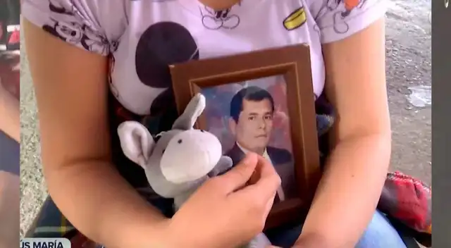 Menor se vacuna contra la COVID-19 acompañada de la foto de su padre fallecido en pandemia