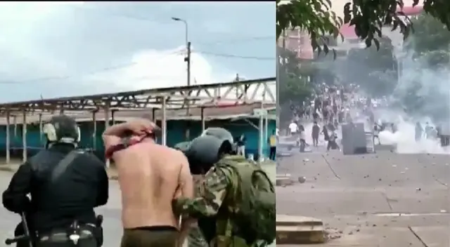 Policía ayudado por sus compañeros tras ser secuestrado por manifestantes