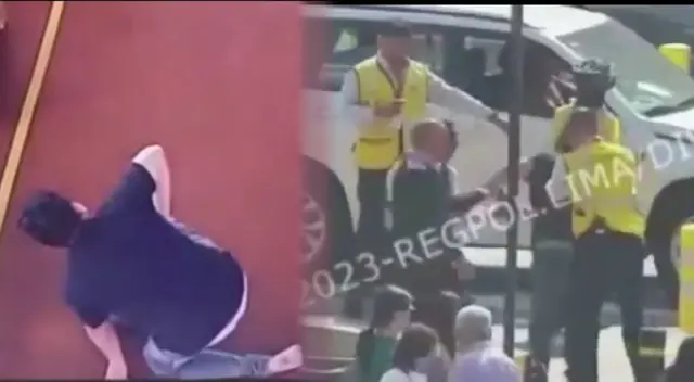 Eric arrodillado en el suelo y a la derecha siendo retenido por seguridad.