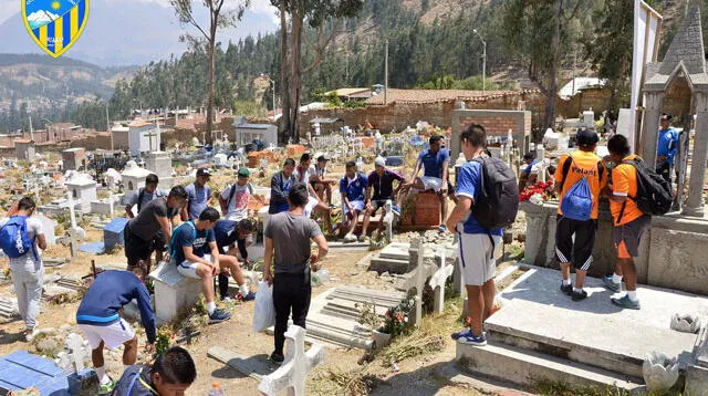 Los jugadores y comando técnico del Sport Rosario rezan en la tumba de su presidente Lombardo Mautino