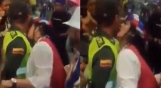 Polémico video registró cuando la mujer besó al uniformado en pleno evento.