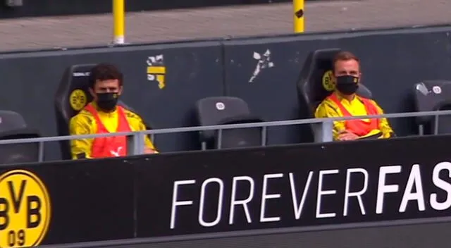 Suplentes del Borussia Dortmund mantiene distanciamiento social y usan mascarillas.