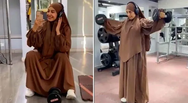 Una mujer joven con un traje de entrenamiento hijab se pone en